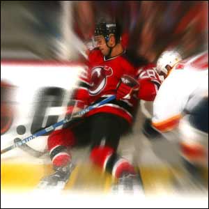 Rafalski and Weiss battle for the puck