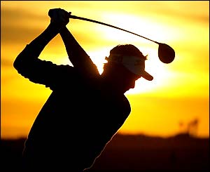 Sweden's Frederik Jacobsen stands in front of the setting sun at the World Cup of Golf at Kiahwah Island