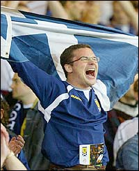 A Scotland fan celebrates his side's win over Holland