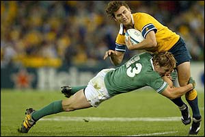 Ireland's Brian O'Driscoll tackles Australia's Matt Rogers