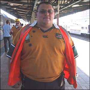 An Australian railway employee shows off his Wallaby shirt