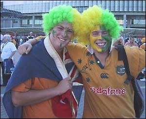Australian fans with painted faces celebrate outside the Telstra Stadium