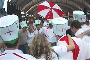 England fans dance and sing in the rain in Sydney