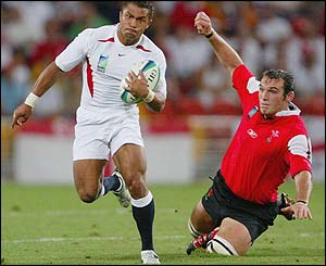Jason Robinson breaks away for England in the quarter-final clash with Wales