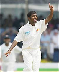 Muralitharan grabs the wicket of Andrew Flintoff