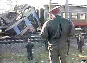 Policemen look at the wreckage of the commuter train 