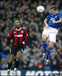 Everton's Alan Stubbs heads the ball away from Nicolas Anelka as Man City