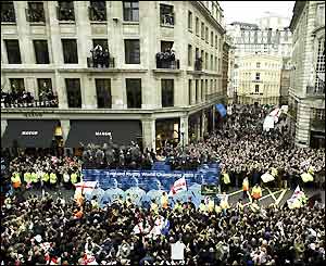 Office workers hang out of their windows in Regent Street
