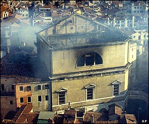 Smoke rises from the wrecked opera house following the fire