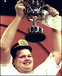 Raymond van Barneveld shows off the trophy in 1999