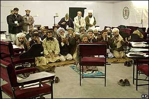 Delegates pray at the loya jirga