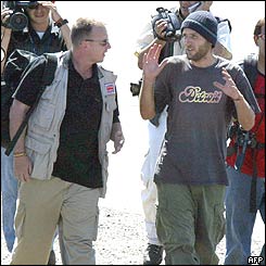 Mark Henderson (right) as the media close in