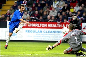 Adrian Mutu sees his shot saved by Dean Keily