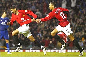 Kleberson wheels away after scoring, chased by David Bellion