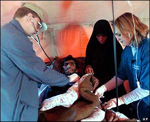 Dr Victor Kozachkov (l) and nurse Natasha Bondarchuk (r) examine an earthquake survivor 