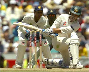 Australian opener Justin Langer sweeps the ball