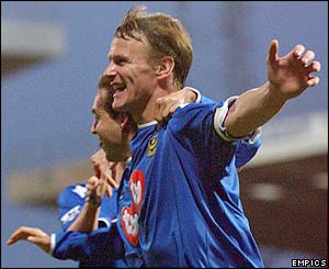 Teddy Sheringham celebrates with his team-mates after putting Portsmouth 3-2 up