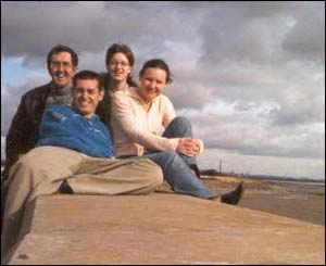 Edson from Brazil, Birgit from Germany, Celine from France and Tone from Wales enjoying sunshine on the seawall at St.Brides, between Cardiff and Newport (Birgit Hartmann)