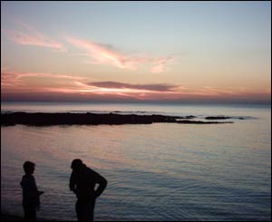 Two students skimming stones on the beach at Aberystwyth (Owen Jones)