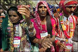 Two Indian eunuchs (centre and right) join Indian low-income widows in a protest march 