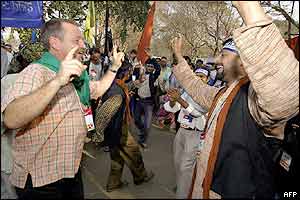 French anti-globalisation activist Jose Bove (left) dances with a Dalit, lowest caste of Hindus