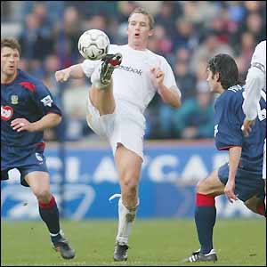 Portsmouth defenders keep a close eye on Bolton striker Kevin Davies