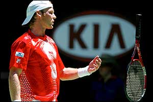 Rainer Schuettler throws his racket in disgust during his defeat to Robin Soderling