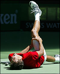 John Van Lottum holds his leg in agony after suffering cramp against Gustavo Kuerten 