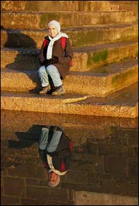 Jim Young's wife Sue reflected in a pool beneath the sea wall at Swansea
