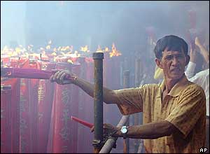 Man with joss sticks at Dharma Bhakti Temple, in Jakarta, Indonesia