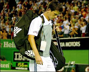 Tim Henman leaves the court after defeat by Guillermo Canas