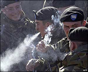 Soldiers take a cigarette break before parading before Georgia's new president