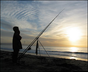 A lone fisherman braves the early morning chill in Swansea Bay (Jim Young)
