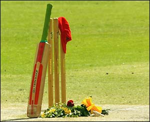 A red South Australian cap and bat adorn the stumps as a moving tribute to David Hookes