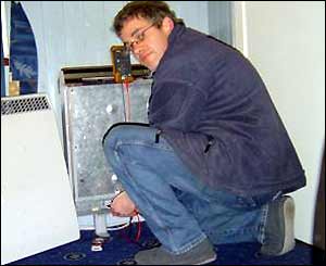 Russell attends to a faulty heater