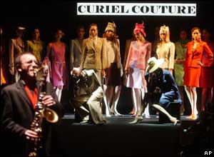 A solo sax calls models on the catwalk at the start of the Raffaella Curiel Spring and Summer 2004 fashion collection, presented in Rom