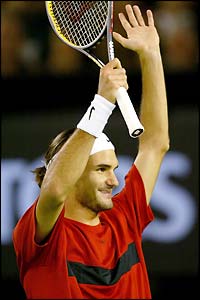 Roger Federer salutes the crowd after victory