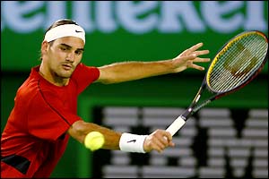 Roger Federer plays a backhand volley