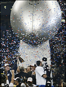 New England celebrate in front of a giant replica of the Vince Lombardi Trophy