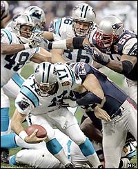 Carolina Panthers quarterback Jake Delhomme (17) is sacked for a nine yard loss by New England Patriots linebacker Mike Vrabel in the first quarter of Super Bowl XXXVIII