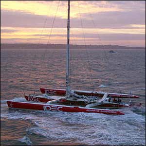 Joyon's trimaran IDEC against the backdrop of the rising sun