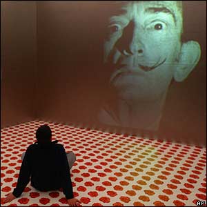 Man sits to look at Dali installation