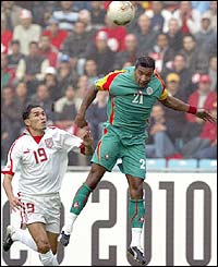 Tunisia's Karim Saidi fights for the ball with Senegalese defender Habib Beye 