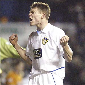 James Milner clenches his fist with delight after scoring Leeds' third