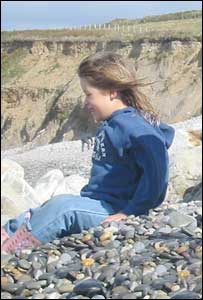 Elen Haf Thomas smiling at the sea at Abermawr Pembrokeshire
