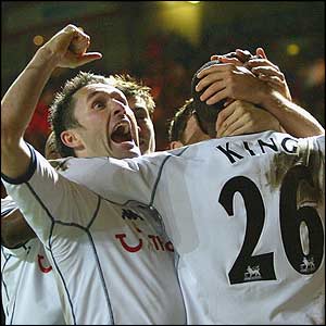Robbie Keane helps Ledley King to celebrate his goal