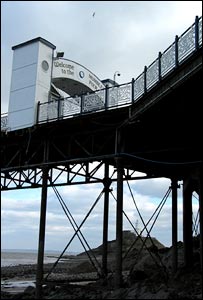 Mumbles pier taken at low tide with the lighthouse visible between the supports of the pier (Jim Young)