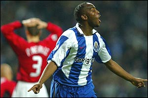 Phil Neville can only stand in despair as McCarthy celebrates