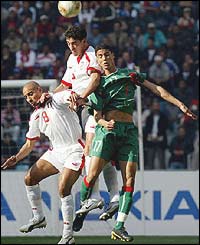 Tunisia midfielders Mdehi Nafti and Zied Jaziri fight for the ball against Morocco's Matouane Chama