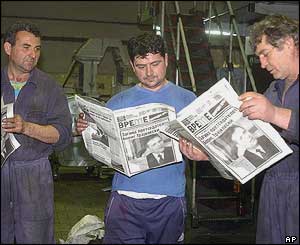 Workers in a Skopje printing shop read a newspaper's special edition
